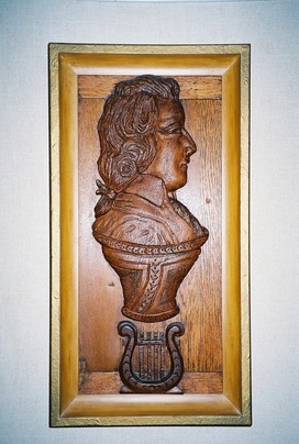 Carved oak panel of Mozart