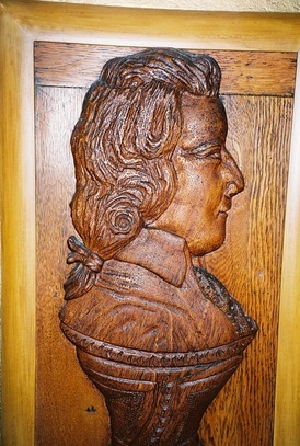 Detail, carved oak relief of Mozart